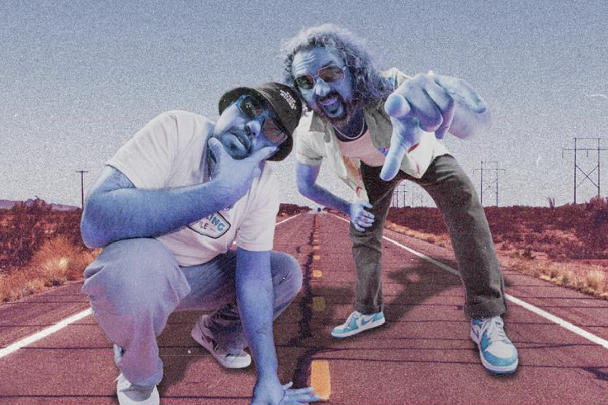 Australian band Bootleg Rascal duo tinted blue posing on a desert highway background, wearing sunglasses, sneakers, and casual streetwear.